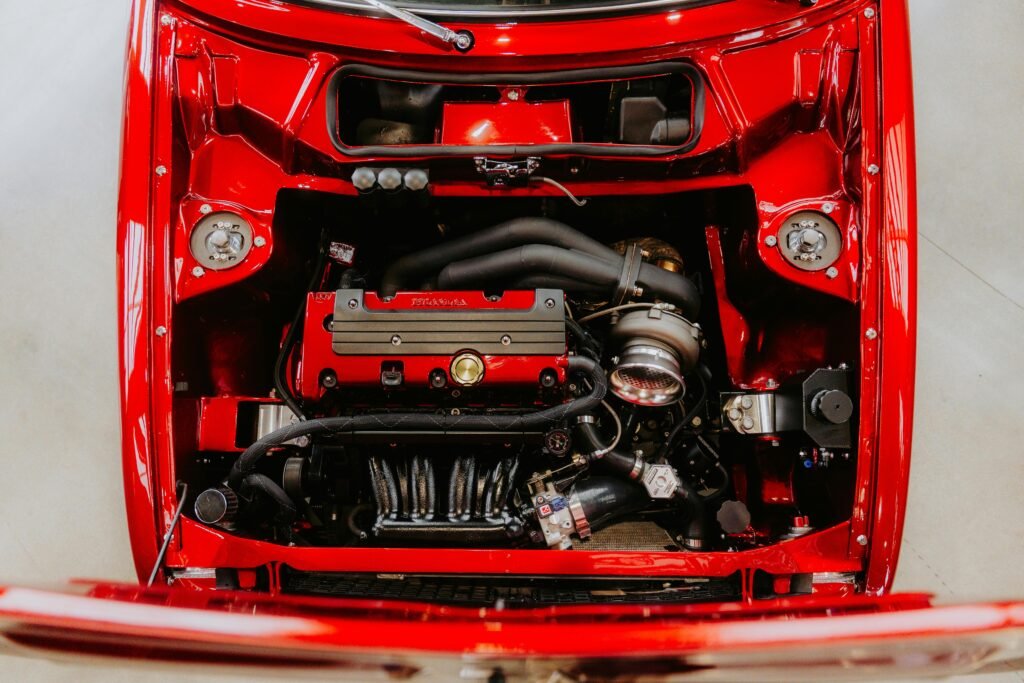 Close-up view of a high-performance red car engine showcasing intricate details and mechanical components.